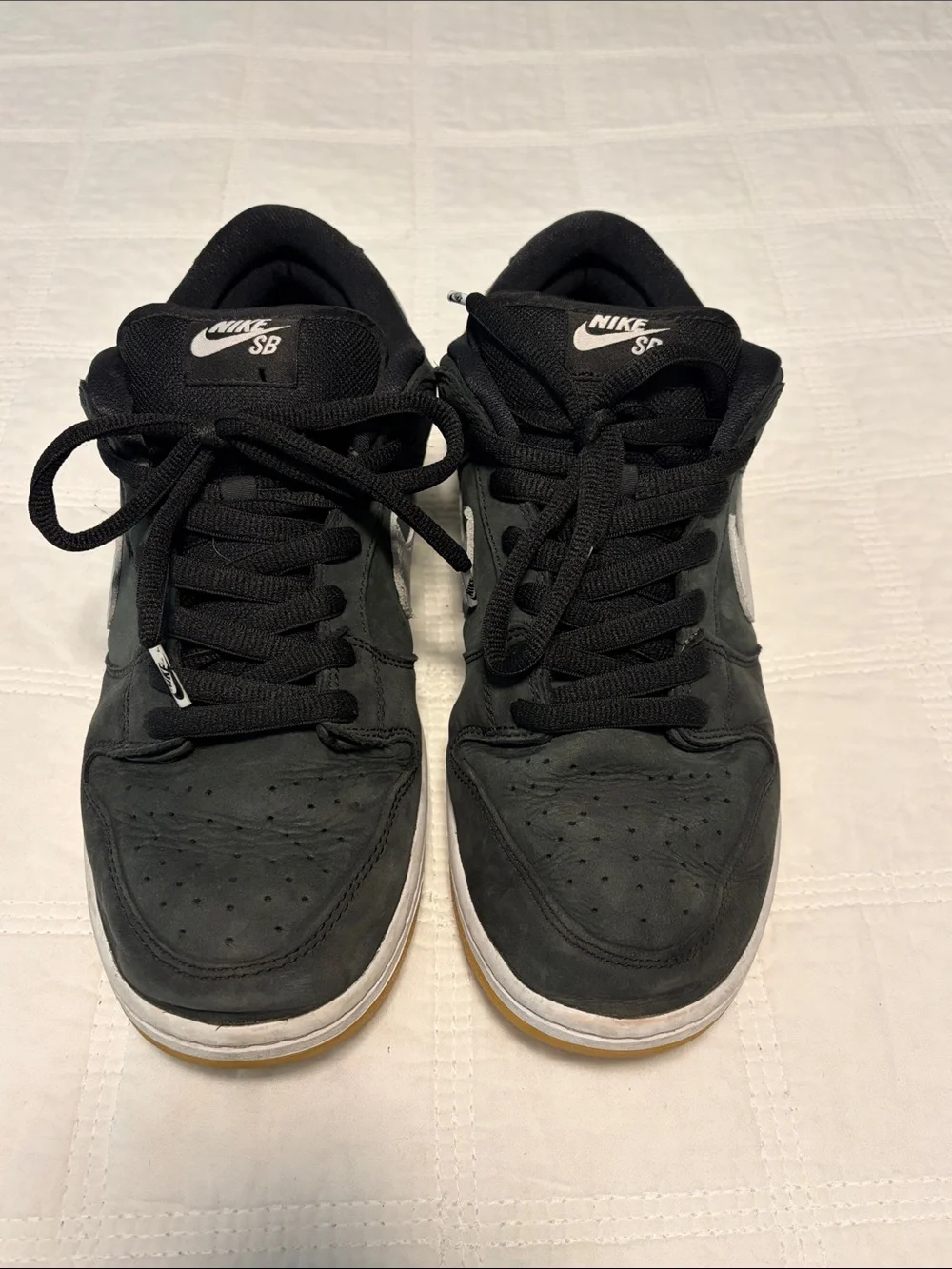 Nike Black Low-Top Sneakers with White Swoosh and Gum Sole